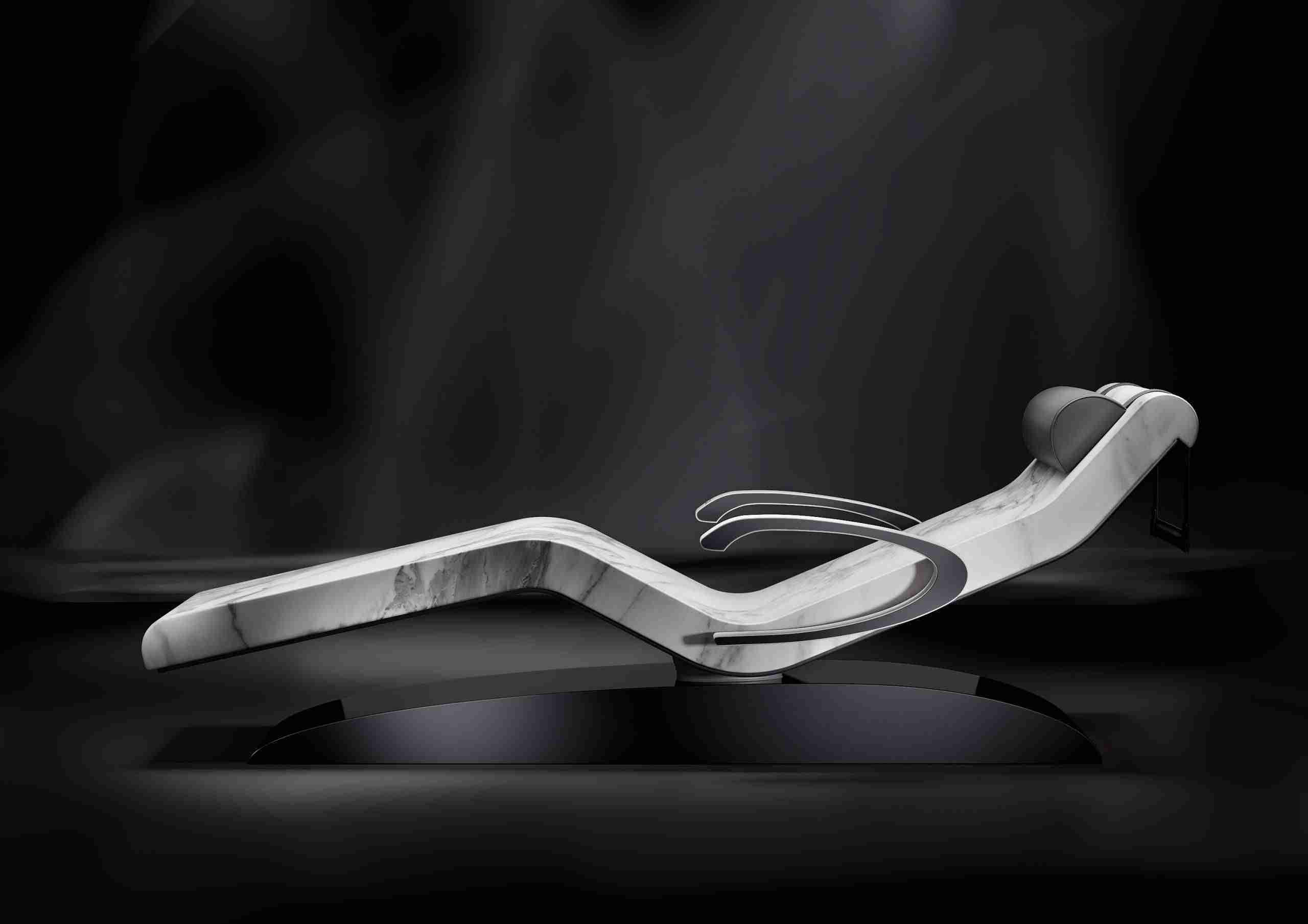 The Cleopatra Moderno Heated Lounger With Side Armrests Shown In Marble Finish. An Exclusive Design By Fabio Alemanno, Combining Ergonomic Comfort, Wellness Technology, And Italian Craftsmanship For High-End Spas And Resorts.