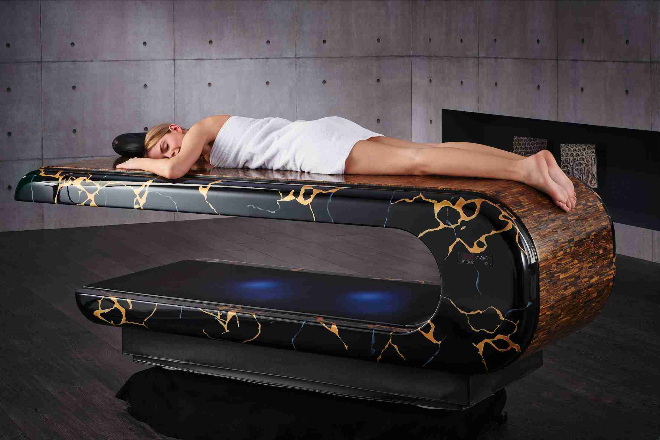 Relaxation Moment On A Heated Massage Table In Semiprecious Tiger Eye Stone With Elegant Golden Veining.