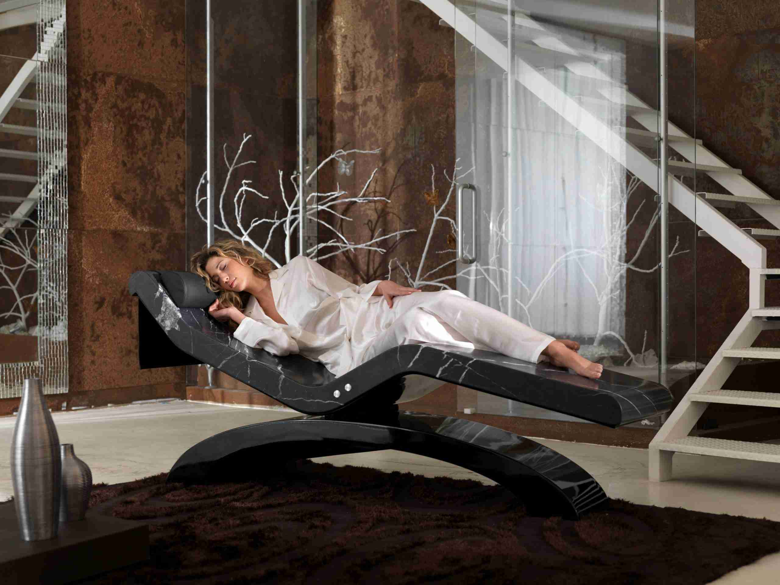 Guest Relaxing On A Cleopatra Heated Marble Lounger In A Private Home Suite Ambience.