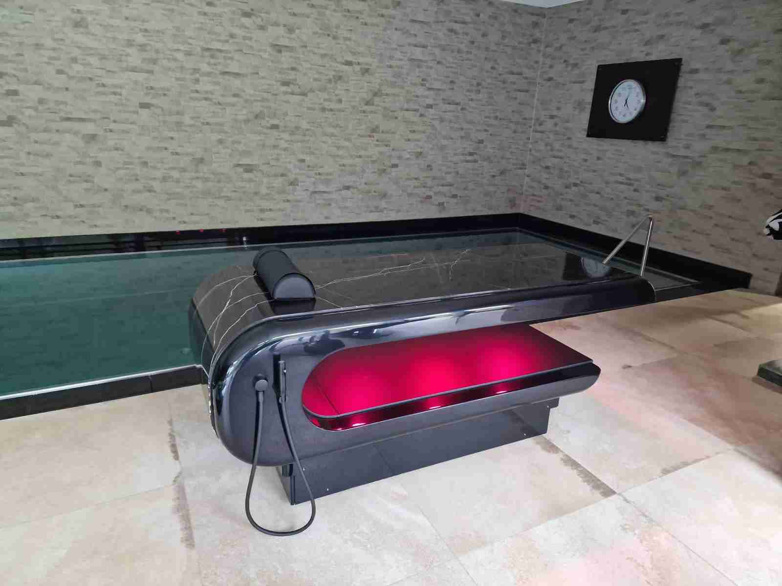 Square Table Heated Stone Massage Table — Poolside Wellness Setup For Treatments With Gentle, Even Warmth.
