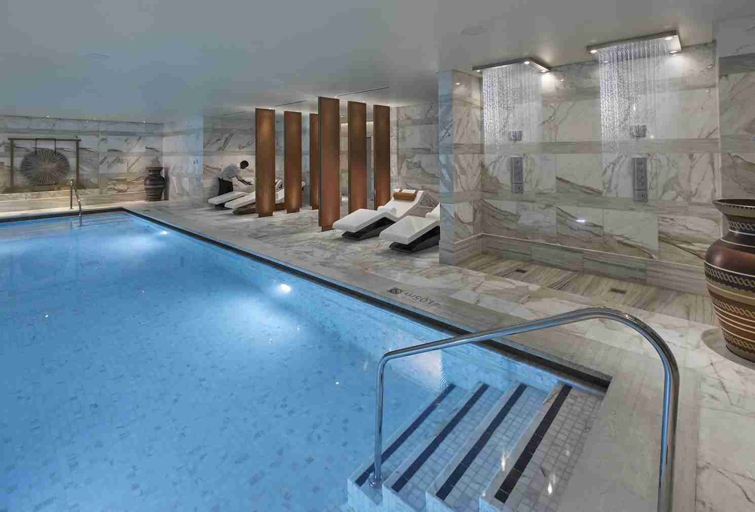 Luxury Spa Pool Setting In Doha With Refined Wellness Atmosphere And Warm Material Palette