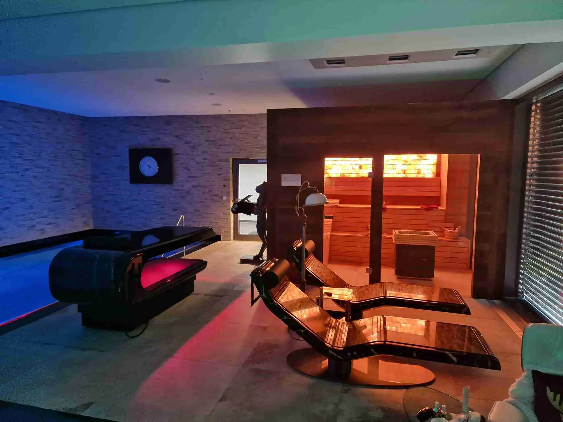 Square Table heated stone massage table paired with heated loungers — private wellness space with coordinated spa design.