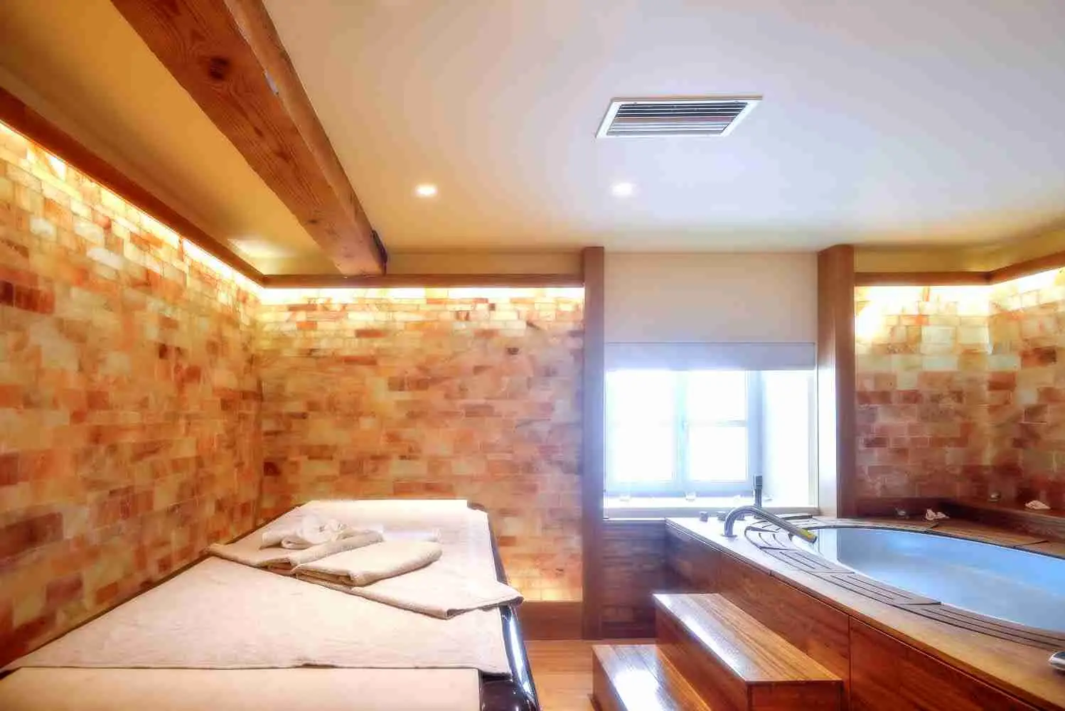 Square Table heated stone table — spa wellness retreat suite view with refined materials and consistent therapeutic warmth.